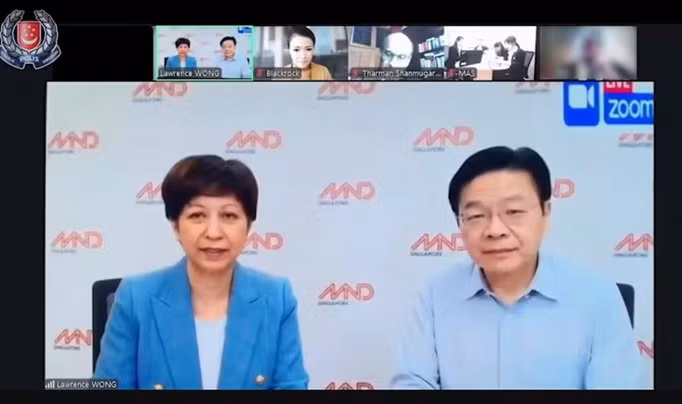 Ảnh chụp màn hình đoạn video do AI tạo ra, mô phỏng một cuộc họp video Zoom với các quan chức cấp cao của Chính phủ Singapore, bao gồm Thủ tướng Lawrence Wong (bên phải) và Bộ trưởng Indranee Rajah. Ảnh: Lực lượng Cảnh sát Singapore untitled-783.png